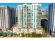 Aerial view of a modern highrise building with pool and city backdrop at 450 Knights Run Ave # 705, Tampa, FL 33602