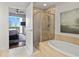 Bathroom with shower, bathtub, and view into bedroom at 450 Knights Run Ave # 705, Tampa, FL 33602