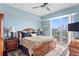 Relaxing bedroom with ceiling fan and access to private balcony at 450 Knights Run Ave # 705, Tampa, FL 33602