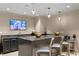 Community lounge with bar, seating, and large screen TV at 450 Knights Run Ave # 705, Tampa, FL 33602