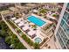 Luxury pool area with multiple lounge chairs, shade structures, and a hot tub at 450 Knights Run Ave # 705, Tampa, FL 33602
