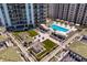 Relaxing pool deck featuring a refreshing pool, lush landscaping, and outdoor seating at 450 Knights Run Ave # 705, Tampa, FL 33602