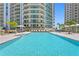 Inviting resort-style pool with plenty of lounge chairs at 450 Knights Run Ave # 705, Tampa, FL 33602