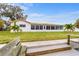 Spacious backyard with a view of the canal, lush lawn, and a wooden bench at 4500 38Th S St, St Petersburg, FL 33711