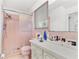 Bathroom with pink tile, a shower, and a vanity with ample counter space at 4500 38Th S St, St Petersburg, FL 33711