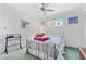 Bedroom with brass bed frame, green carpet and ceiling fan at 4500 38Th S St, St Petersburg, FL 33711