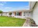 Front view of a ranch style home featuring white brick and a covered entryway at 4500 38Th S St, St Petersburg, FL 33711