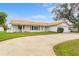 White single story home with terracotta roof and circular driveway at 4500 38Th S St, St Petersburg, FL 33711