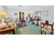 Bright living room featuring a green carpet, comfy sofas, and antique furniture at 4500 38Th S St, St Petersburg, FL 33711