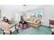 Living room with a beige sofa and a view of the front yard at 4500 38Th S St, St Petersburg, FL 33711