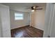 Bedroom with wood-look floors, a window, and a closet at 4939 Docner St, New Port Richey, FL 34652