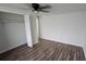 Bright bedroom with wood-look floors and spacious closet at 4939 Docner St, New Port Richey, FL 34652