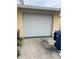 Single car garage with white door at 4939 Docner St, New Port Richey, FL 34652