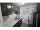 Kitchen with dark cabinets, granite countertops, and a back door at 4939 Docner St, New Port Richey, FL 34652