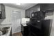 Modern kitchen with black appliances, granite countertops, and ample cabinet space at 4939 Docner St, New Port Richey, FL 34652