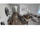 Spacious living room featuring wood-look floors, comfortable furniture, and a large mirror at 4939 Docner St, New Port Richey, FL 34652