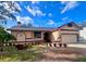 Inviting home exterior featuring a landscaped front yard and attached garage at 4940 Cardinal Trl, Palm Harbor, FL 34683