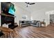 Cozy living room with a fireplace and hardwood floors at 4940 Cardinal Trl, Palm Harbor, FL 34683