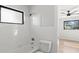 Clean bathroom with white tile and bathtub at 5215 Dover Ne St, St Petersburg, FL 33703