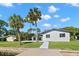 Back exterior view showing updated home and walkway to dock at 5215 Dover Ne St, St Petersburg, FL 33703
