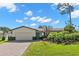 Beautiful mid-century modern home with a landscaped lawn and paver driveway at 5215 Dover Ne St, St Petersburg, FL 33703