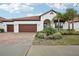 Single-story home with two-car garage and a well-manicured lawn at 5305 Tulip Drop Dr, Wimauma, FL 33598