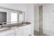 Modern bathroom with double vanity, large mirror, and stone shower at 573 Rose Apple Cir, Port Charlotte, FL 33954