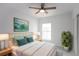 Bright bedroom with a queen bed, window, and ceiling fan at 573 Rose Apple Cir, Port Charlotte, FL 33954