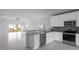 Modern kitchen with gray countertops, white cabinets, and stainless steel appliances at 573 Rose Apple Cir, Port Charlotte, FL 33954