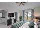 Main bedroom with TV, dresser, and view of backyard at 573 Rose Apple Cir, Port Charlotte, FL 33954