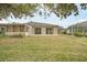 Back of house, sliding doors, and fenced patio at 5742 Heronpark Pl, Lithia, FL 33547