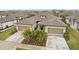Two-story home with a two-car garage and landscaping at 6320 Cliveden Ct, Apollo Beach, FL 33572