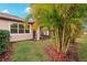Landscaped backyard with palm trees and screened porch at 6320 Cliveden Ct, Apollo Beach, FL 33572