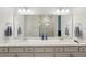 Bathroom with a double vanity and a large mirror at 6320 Cliveden Ct, Apollo Beach, FL 33572