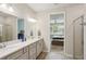 Main bathroom features a double vanity and a shower at 6320 Cliveden Ct, Apollo Beach, FL 33572