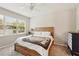 Bright bedroom with wooden bed frame and large window at 6320 Cliveden Ct, Apollo Beach, FL 33572