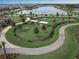 Aerial view of a fenced dog park with benches and waste disposal stations at 6320 Cliveden Ct, Apollo Beach, FL 33572