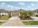 Two-story home with a two-car garage and landscaping at 6320 Cliveden Ct, Apollo Beach, FL 33572