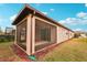 Home exterior showcasing screened porch and landscaping at 6320 Cliveden Ct, Apollo Beach, FL 33572