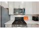 Modern kitchen features stainless steel appliances and white cabinets at 6320 Cliveden Ct, Apollo Beach, FL 33572