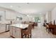 Open kitchen with island and view of living and dining area at 6320 Cliveden Ct, Apollo Beach, FL 33572