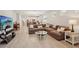 Spacious living room with large sectional sofa and access to backyard patio at 6320 Cliveden Ct, Apollo Beach, FL 33572