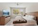 Spacious main bedroom with a large bed, a TV, and plenty of natural light at 6320 Cliveden Ct, Apollo Beach, FL 33572