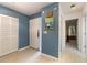 Bright entryway with light wood flooring, white louvered doors, and a view of the living area at 804 67Th W St, Bradenton, FL 34209
