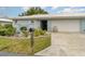 Light blue house with a white roof, landscaped yard, and a two-car garage at 804 67Th W St, Bradenton, FL 34209