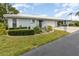Front view of a light blue house with nicely landscaped grounds and a two-car garage at 804 67Th W St, Bradenton, FL 34209