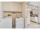 Bright laundry room with washer, dryer, and ample cabinet space at 804 67Th W St, Bradenton, FL 34209