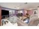 Living room with purple walls, brown furniture, and a large TV at 804 67Th W St, Bradenton, FL 34209