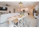 Bright dining area with a farmhouse table and adjacent kitchen at 8203 Abalone Loop, Parrish, FL 34219