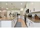 Modern kitchen with white cabinets, granite countertops, and stainless steel appliances at 8368 Greenway Ave, Wesley Chapel, FL 33544